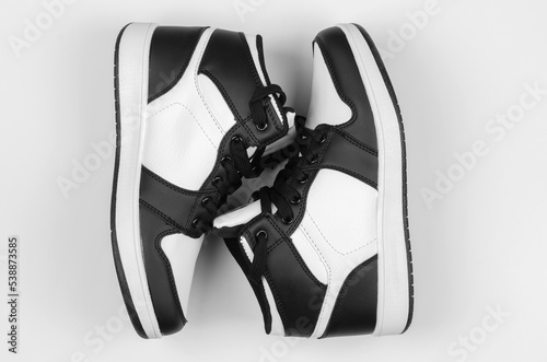 A pair of sneakers on a white background. Stylish new sneakers for advertising a shoe store