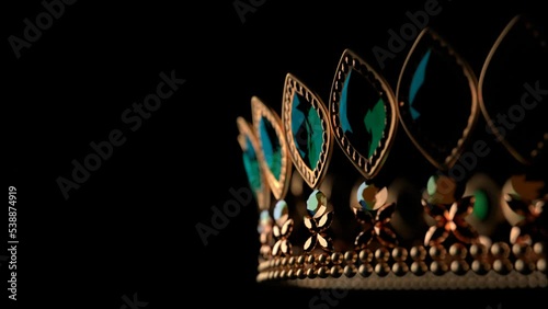 Golden crown with brilliants on black background 3D 4K looped animation with copy space. Sparkling royal corona. Close-up. photo