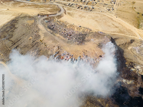 Aerial view of landfill with burning trash piles © Collab Media