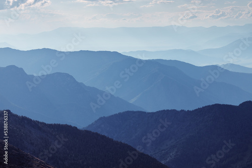 Beautiful mountain landscape in the haze. Horizon blue gradient.