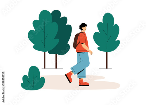Young man walking in the summer forest 