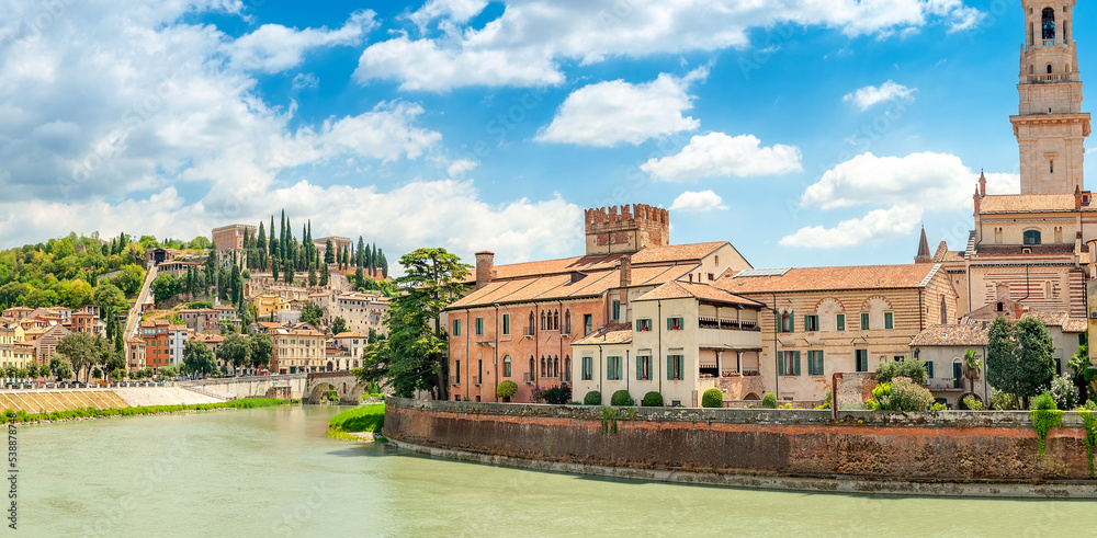 Panorama of the Ponte Pietra bridge and the city of Verona on the banks of the river with historical buildings and towers, Italy, Europe