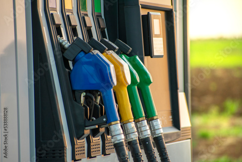 Wallpaper Mural fuel guns at the fuel station and green field in the background Torontodigital.ca