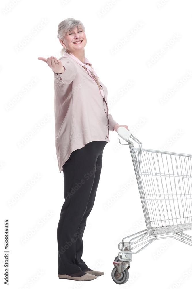elderly lady with a shopping cart looking at you with a smile. elderly lady with a shopping cart looking at you with a smile.
