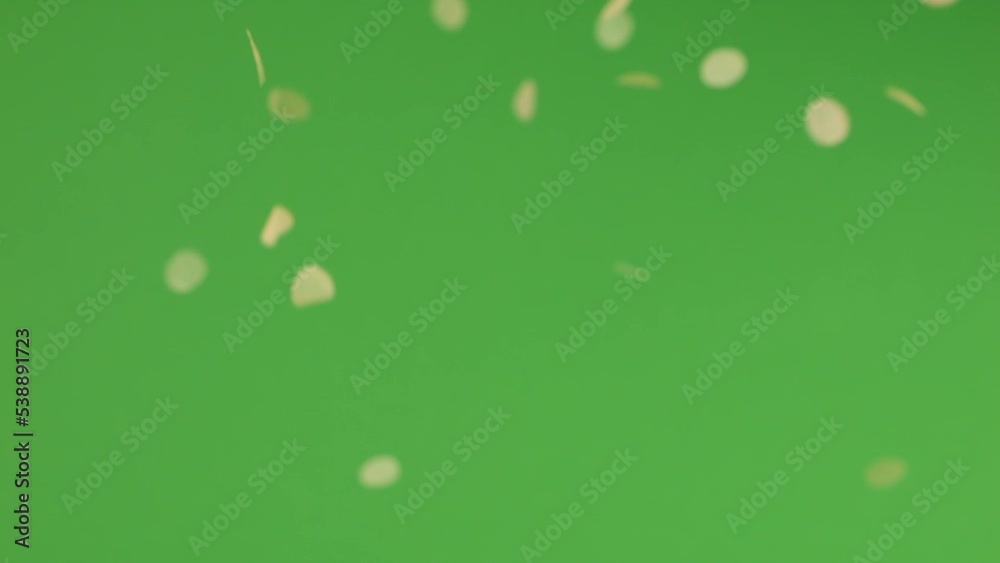 Falling confetti on a green background. Falling confetti on a green background.