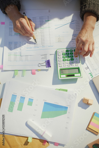 accountant woman with calculator and documents working