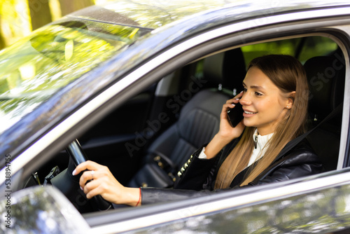 Young woman using her phone while driving the car © F8  \ Suport Ukraine