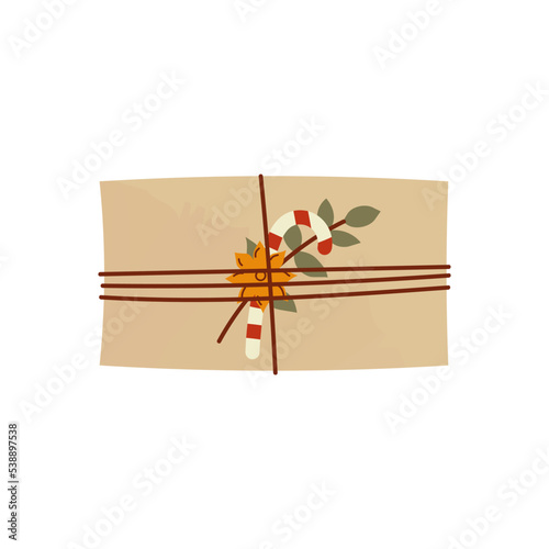 Christmas gift in kraft paper with lolipop, carnation and leaves. Cute present box in craft wrapping flat vector illustration isolated on white background.