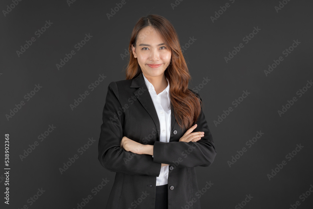 Business woman wearing a black suit Standing with arms crossed. Business woman wearing a black suit Standing with arms crossed.