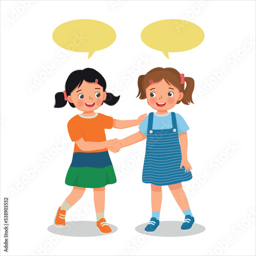 Two cute little girls shaking hands making introduction or congratulating to each others