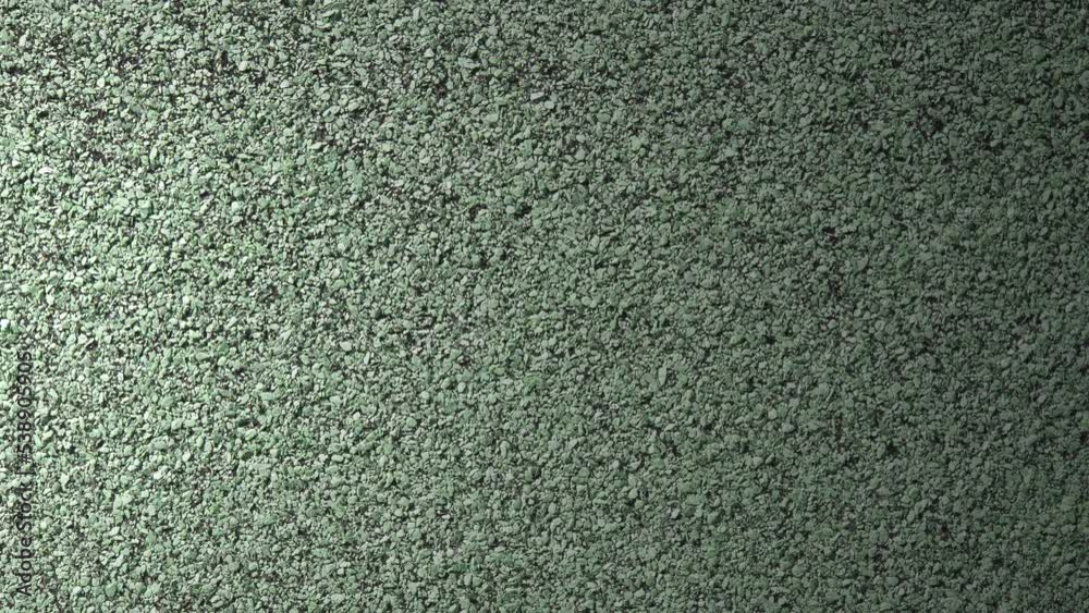 Light effect on green soft rubber granular flooring surface 4k Light effect on green soft rubber granular flooring surface 4k