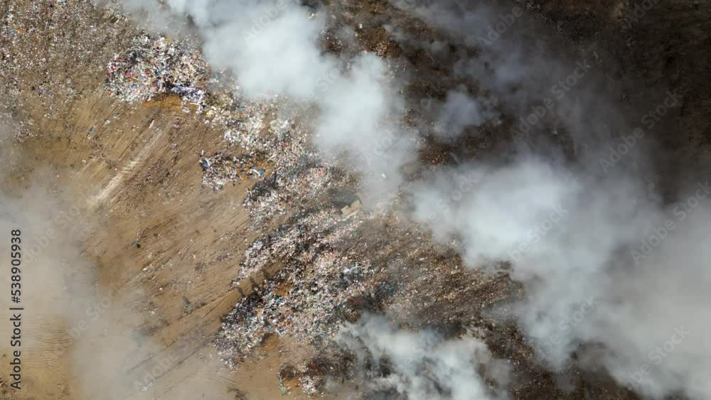 Aerial view of landfill with burning trash piles Aerial view of landfill with burning trash piles