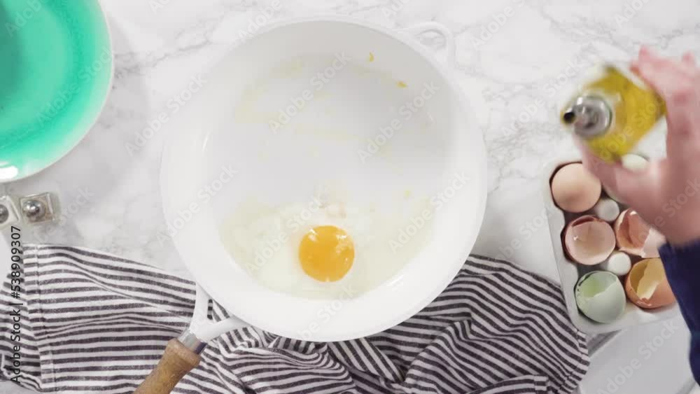 Flat lay. Frying farm fresh eggs in a white skillet. Flat lay. Frying farm fresh eggs in a white skillet.
