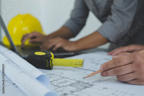 Team of engineers and architects, working team, meeting, discussing construction and drawing construction plans, printing, writing on-site construction sites. Home design concept