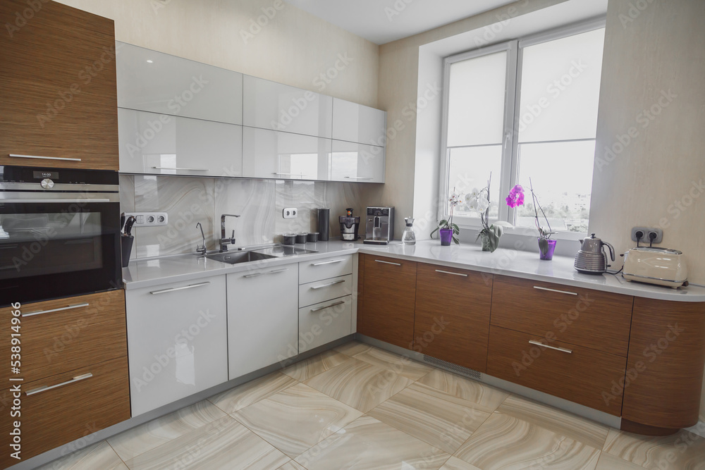 View of luxury modern fitted kitchen with stainless steel appliances View of luxury modern fitted kitchen with stainless steel appliances