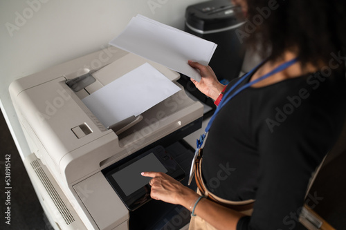 Woman standing near the xerox in the office