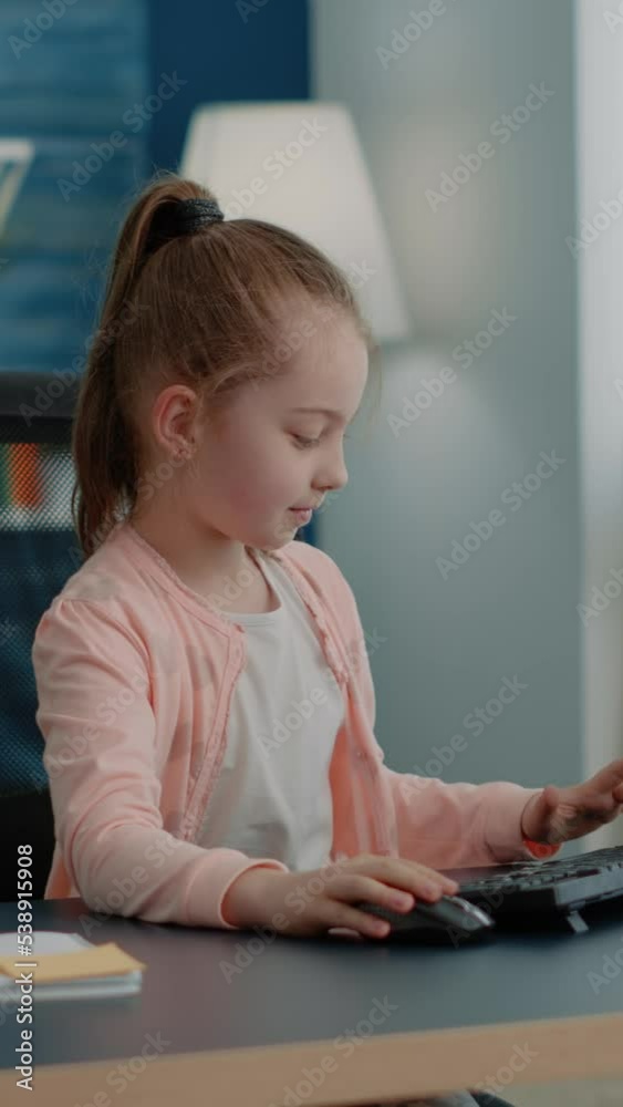 Vertical video: Pupil using keyboard and computer for online class ...