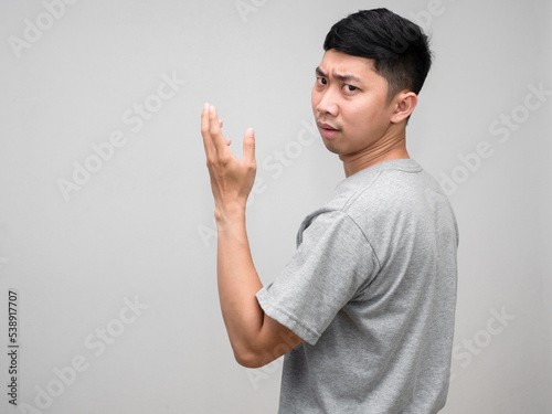 Portrait asian man grey shirt feels worried and  confused turn around to loking at you isolated