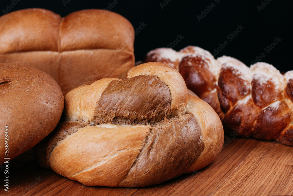 Fresh baked bread on a rustic wooden table. High quality photo