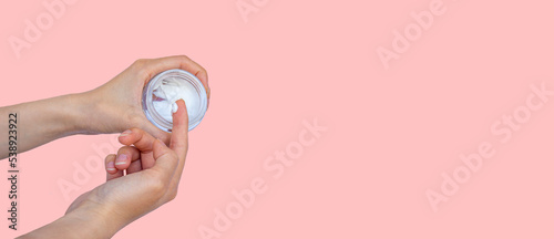Fototapeta Naklejka Na Ścianę i Meble -  Hand with moisturizer cream. Skin care concept photo. Web banner. Large copy space area.