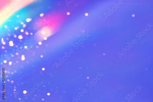 Abstract holographic background with gold bokeh Blurred rainbow texture in violet