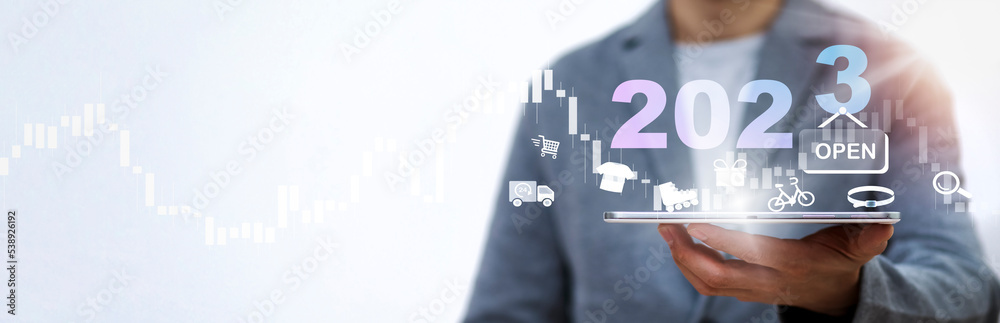 Open shopping in 2023 concept, Businessman holding tablet bar graph of analytics and financial, Changes in new planning, Business growth, ideas and perspectives, Stock investment, and dividends yield.