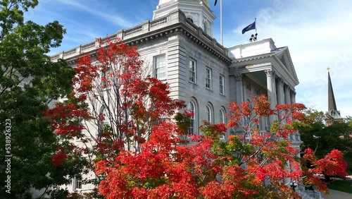 New Hampshire State House, Capitol building with gold dome in Concord. Autumn fall foliage with colorful tree leaves. photo