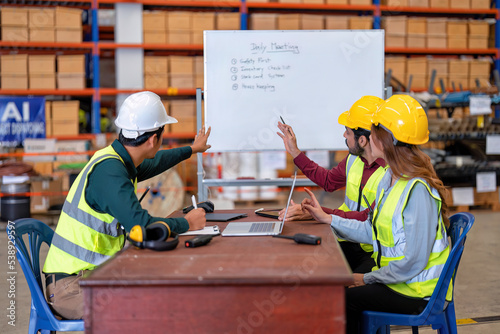 Group of worker in the warehouse factory conduct toolbox talk daily meeting focus on safety priority and house keeping in the morning before start working photo