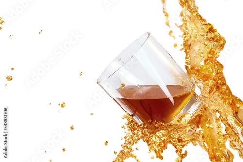 Drink drops around whisky glass on white background.