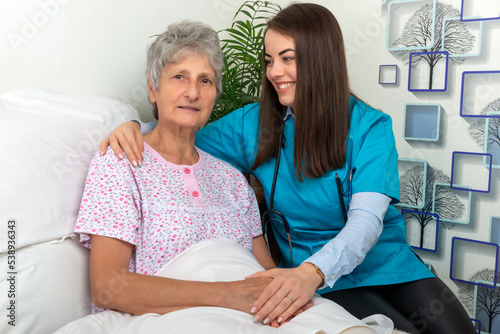 Nurse helping senior woman in hospital