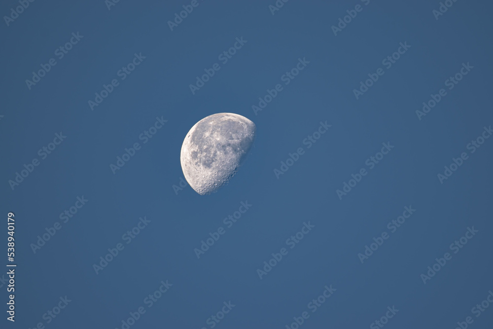 A Waxing moon in the sky in early morning on a Clear Autumn Day as seen in Upstate NY. A Waxing moon in the sky in early morning on a Clear Autumn Day as seen in Upstate NY.