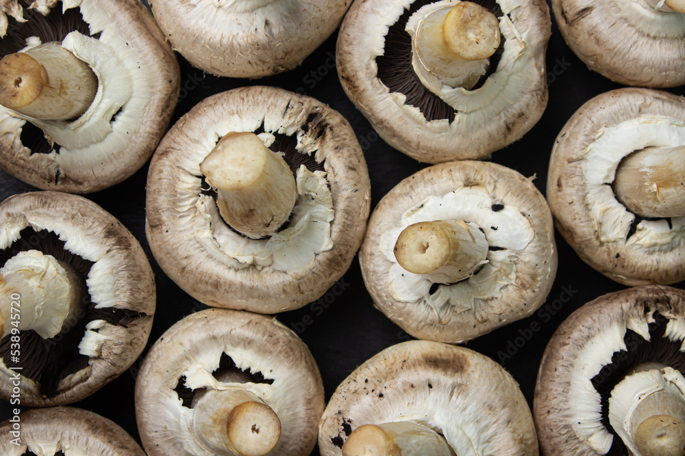 Mushrooms champignons as a background for the image. Fresh delicious mushrooms. Mushrooms champignons as a background for the image. Fresh delicious mushrooms.