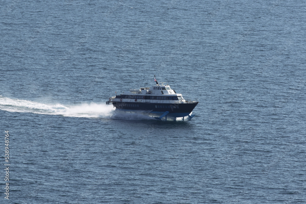 A boat takes tourists between Ischia and Procida. Napoli in Italy Europe. Beautiful holidays A boat takes tourists between Ischia and Procida. Napoli in Italy Europe. Beautiful holidays
