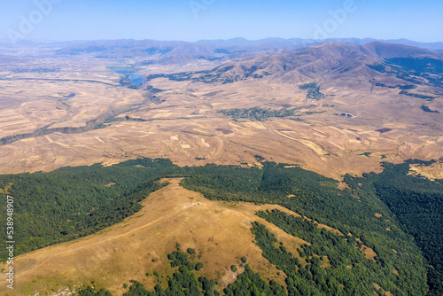 Aerial view of Arailer Mount slope and Aparan water reservoir on sunny summer day. Armenia. © Kirill