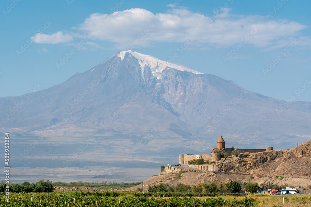 Khor Virap monastery (one of the most popular touristic destinations) on the background of Ararat Mount on sunny summer day. Ararat Province, Armenia.