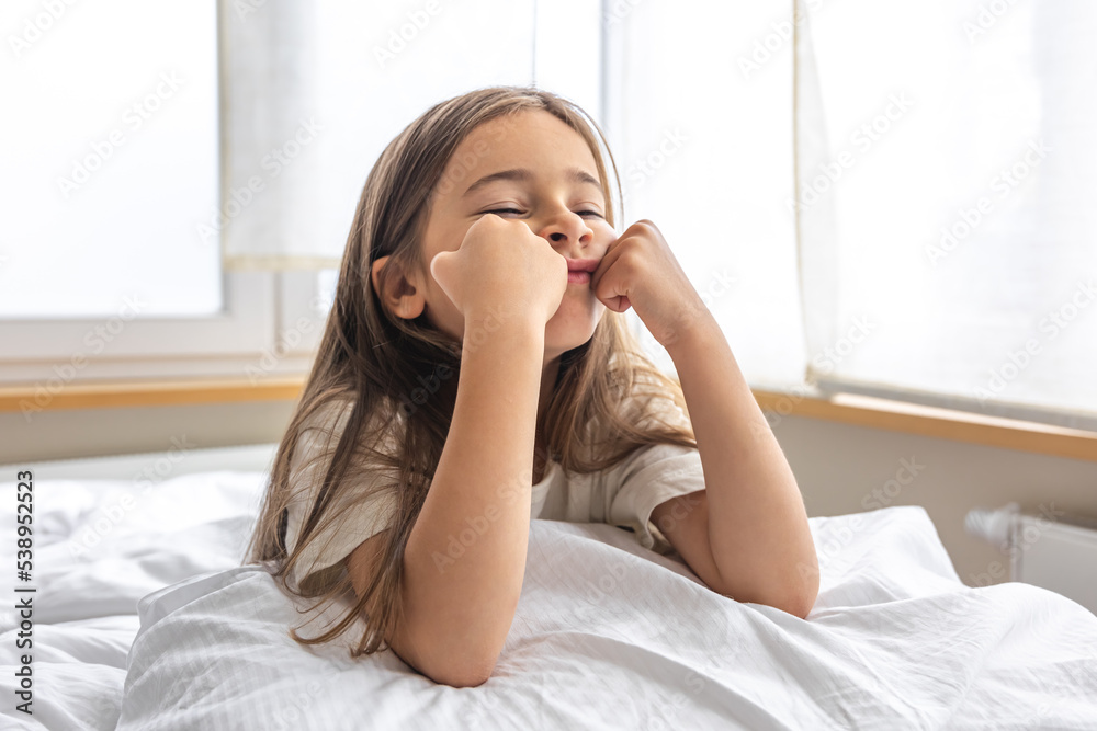 Portrait of a charming little girl in bed early in the morning. Portrait of a charming little girl in bed early in the morning.