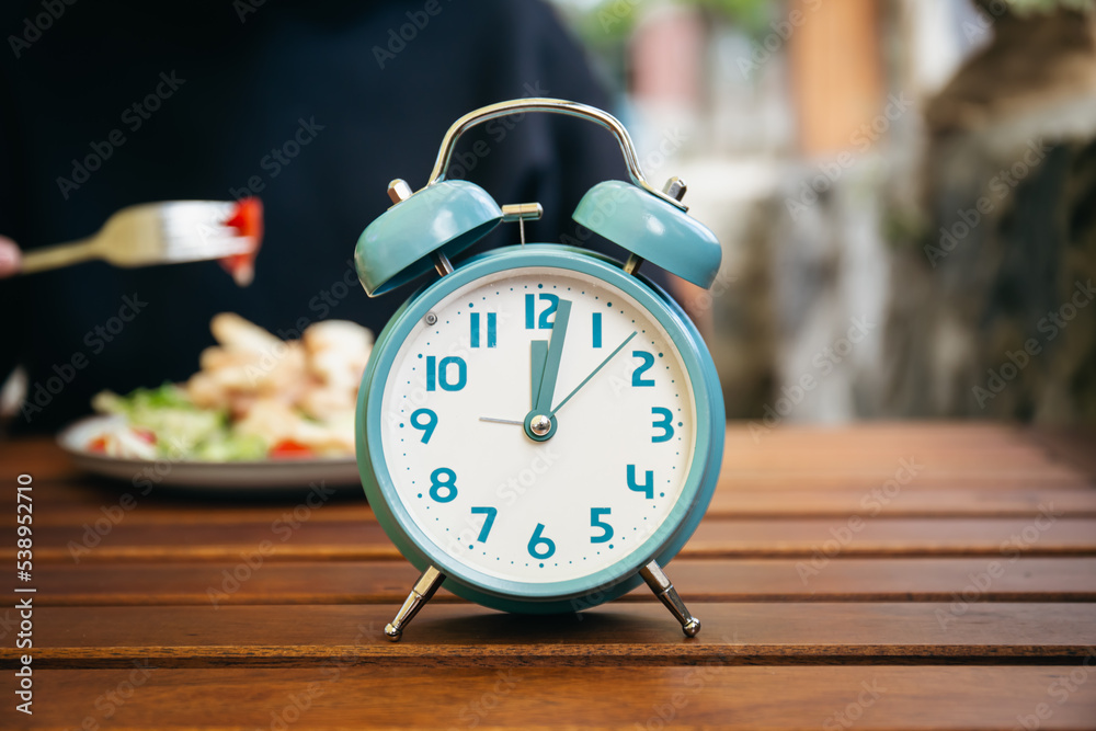 Close-up, alarm clock on a blurred food background. Close-up, alarm clock on a blurred food background.