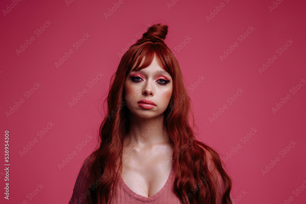 Portrait of a beautiful woman with bright make-up on a pink background in pink clothes Portrait of a beautiful woman with bright make-up on a pink background in pink clothes