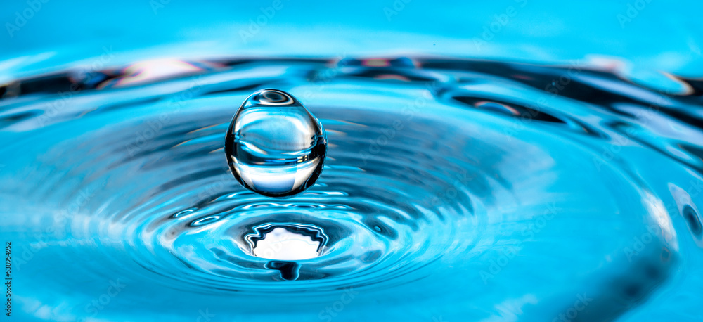 Blue water drop splash on the surface. Blue water drop splash on the surface.
