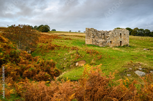 Low Cleughs Bastle next to Cleughs Burn, the ruins of an early 17th century bastle or defensible farmhouse in the Anglo-Scottish Borders as protection against Border Reivers photo