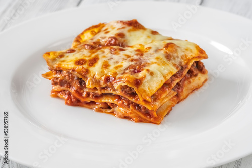 Portion of lasagne on white plate