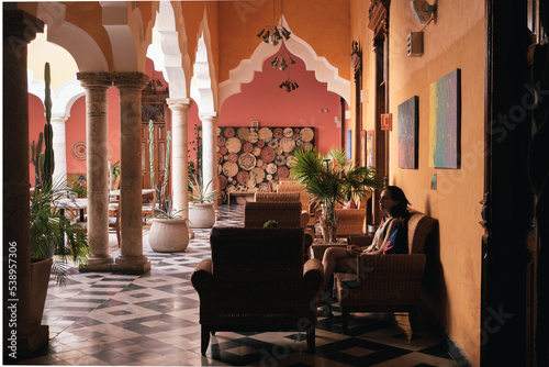 Girl waiting in a chair in a hall of an hacienda 