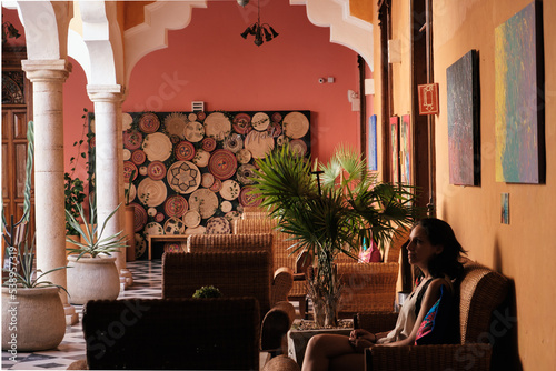 Girl waiting in a chair in a hall of an hacienda  photo