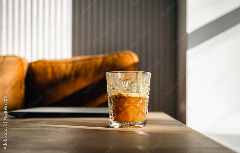 Glass of coffee on the desktop near the laptop early in the morning. Glass of coffee on the desktop near the laptop early in the morning.
