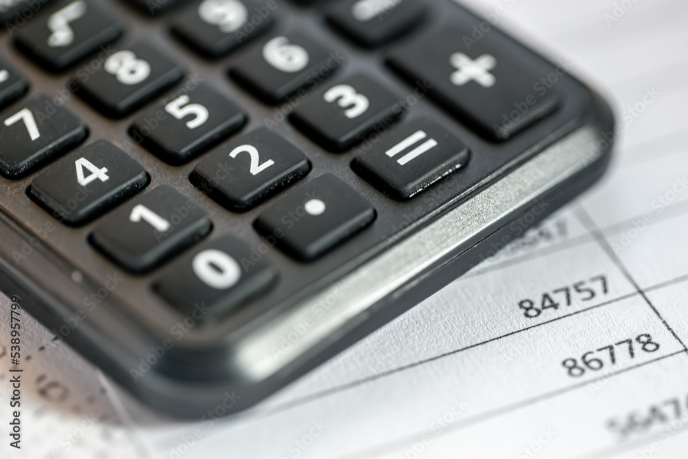 Calculator and numbers on paper closeup, finance concept. Calculator and numbers on paper closeup, finance concept.