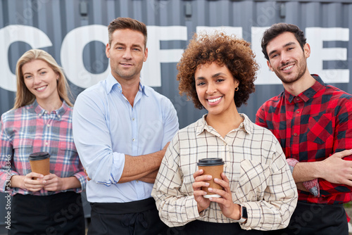 Portrait Of Team Working For Coffee Shop Or Distribution Business Standing By Shipping Container