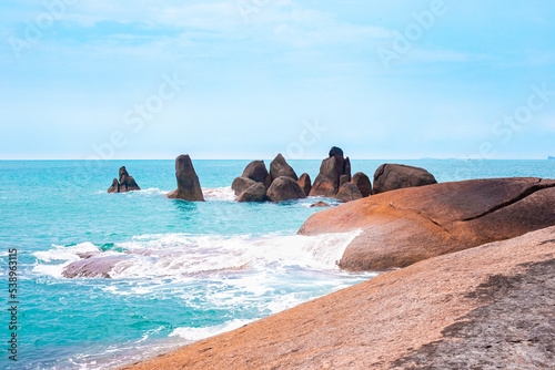 Seascape. Large stones are washed by blue sea waves. Wallpaper on the screen, picture