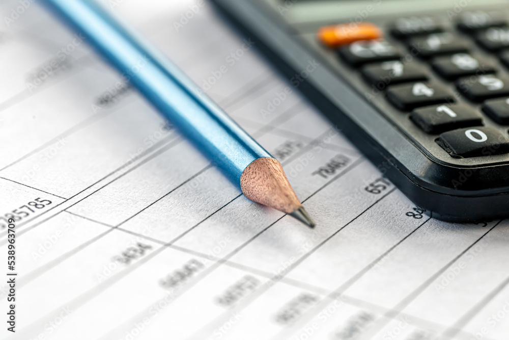 Calculator and pencil close-up on a blurred background. Calculator and pencil close-up on a blurred background.
