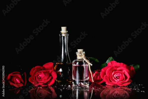Perfume bottles and red roses.