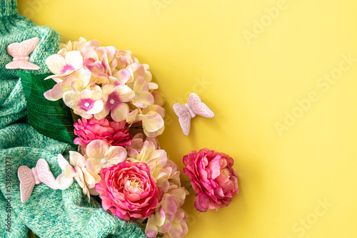 Spring background with flowers and knitted element  flat lay.